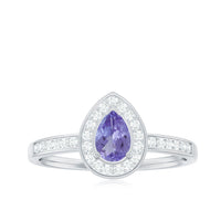 Natural pear-shaped tanzanite engagement ring with diamond halo, set in a Rosec Jewels rings design, featuring a silver band and elegant gemstone.