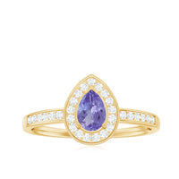 Natural Pear Cut Tanzanite engagement ring with diamond halo, sterling silver setting, featuring a teardrop-shaped purple gemstone.