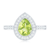 Natural 1 Carat Peridot teardrop engagement ring with diamond halo by Rosec Jewels, showcasing the gemstone and intricate setting.