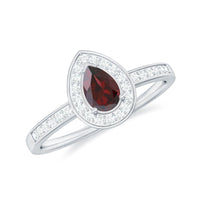Pear-shaped garnet engagement ring with diamond halo by Rosec Jewels, showcasing a classic and elegant design.