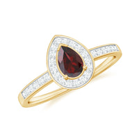 Pear-shaped garnet engagement ring with diamond halo from Rosec Jewels, showcasing a sparkling gemstone and intricate band design.