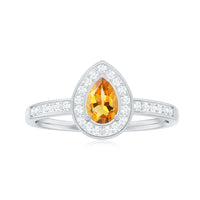 Natural 5x7mm pear-shaped citrine engagement ring with diamond halo from Rosec Jewels, showcasing the sparkling gemstone and elegant setting.