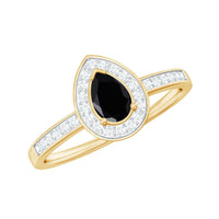 Genuine black spinel teardrop engagement ring with diamond halo, featuring a silver band and intricate detailing.