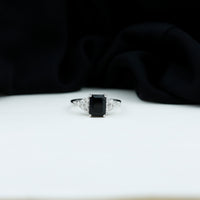 Black onyx engagement ring with emerald cut and diamond accents by Rosec Jewels, showing the detailed design and craftsmanship.