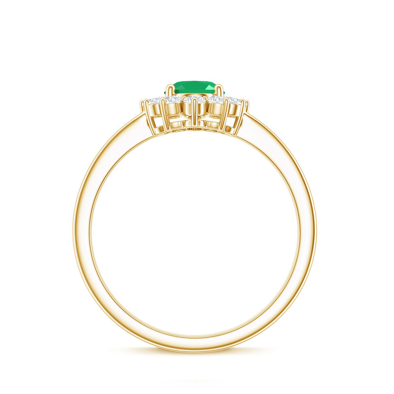 Oval emerald engagement ring with diamond halo, 5x7mm natural gemstone, set in a rose gold band from Rosec Jewels.