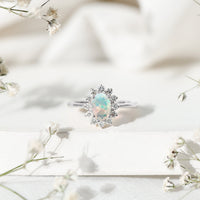 Certified real Ethiopian opal oval engagement ring with diamond halo, showcasing a stunning gemstone and elegant design from Rosec Jewels.
