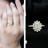 Certified real Ethiopian opal oval engagement ring with diamond halo and rose gold band from Rosec Jewels.