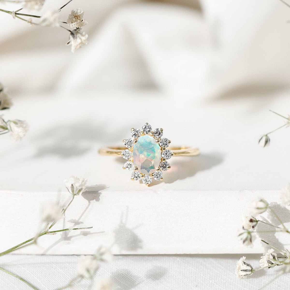 Certified real Ethiopian opal oval engagement ring with diamond halo from Rosec Jewels, featuring a stunning colorful gemstone centerpiece.