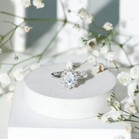 Princess Diana inspired moonstone engagement ring with diamond halo, featuring a silver band and elegant design from Rosec Jewels.
