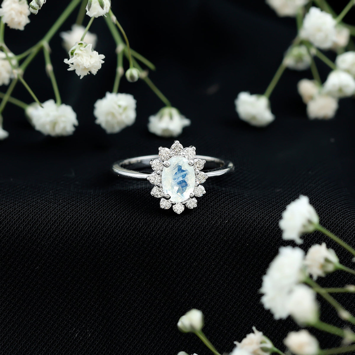 Princess Diana-inspired moonstone engagement ring with diamond halo by Rosec Jewels, featuring a stunning moonstone centerpiece and sparkling accents.