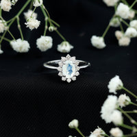 Princess Diana-inspired moonstone engagement ring with diamond halo by Rosec Jewels, featuring a stunning moonstone centerpiece and sparkling accents.