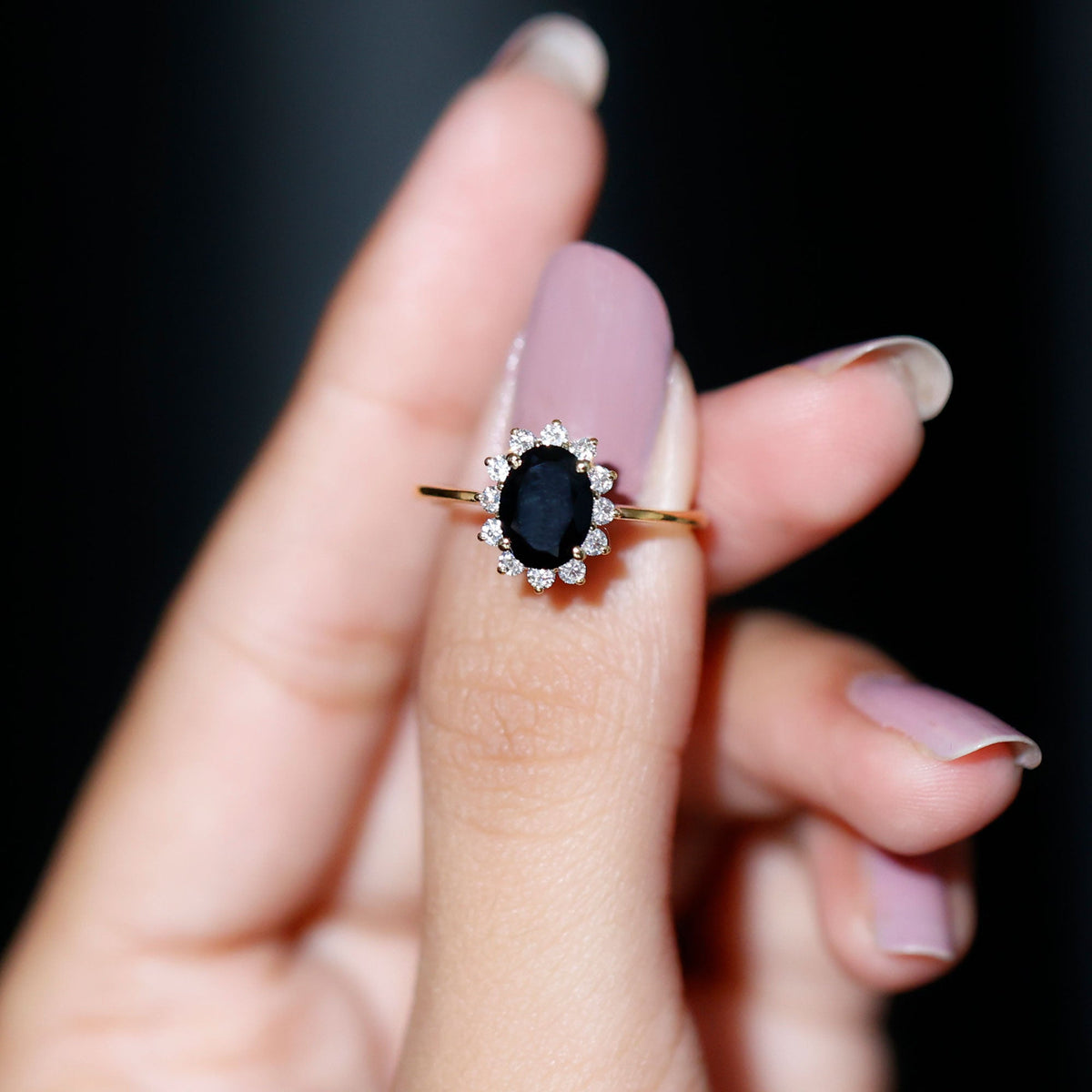 Oval cut black onyx engagement ring with diamond halo from Rosec Jewels, showcasing the elegant design and sparkling stones.