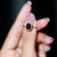 Oval cut black onyx engagement ring with diamond halo from Rosec Jewels, showcasing the elegant design and sparkling stones.