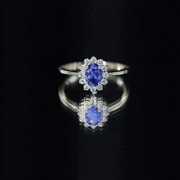 Oval lab-grown blue sapphire engagement ring with diamond halo in yellow gold by Rosec Jewels.