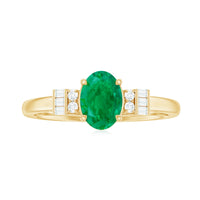 Natural emerald and diamond engagement ring for her featuring a central emerald surrounded by small diamonds, set in a elegant ring band.