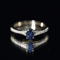 Natural 0.6 carat blue sapphire engagement ring with diamond split shank by Rosec Jewels, showcasing the ring's elegant design.