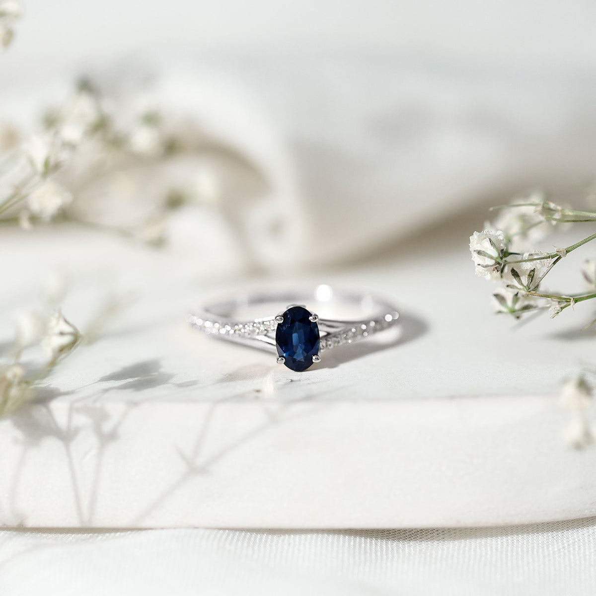 Natural 0.6 carat blue sapphire engagement ring with diamond split shank by Rosec Jewels, featuring a sleek and elegant design.