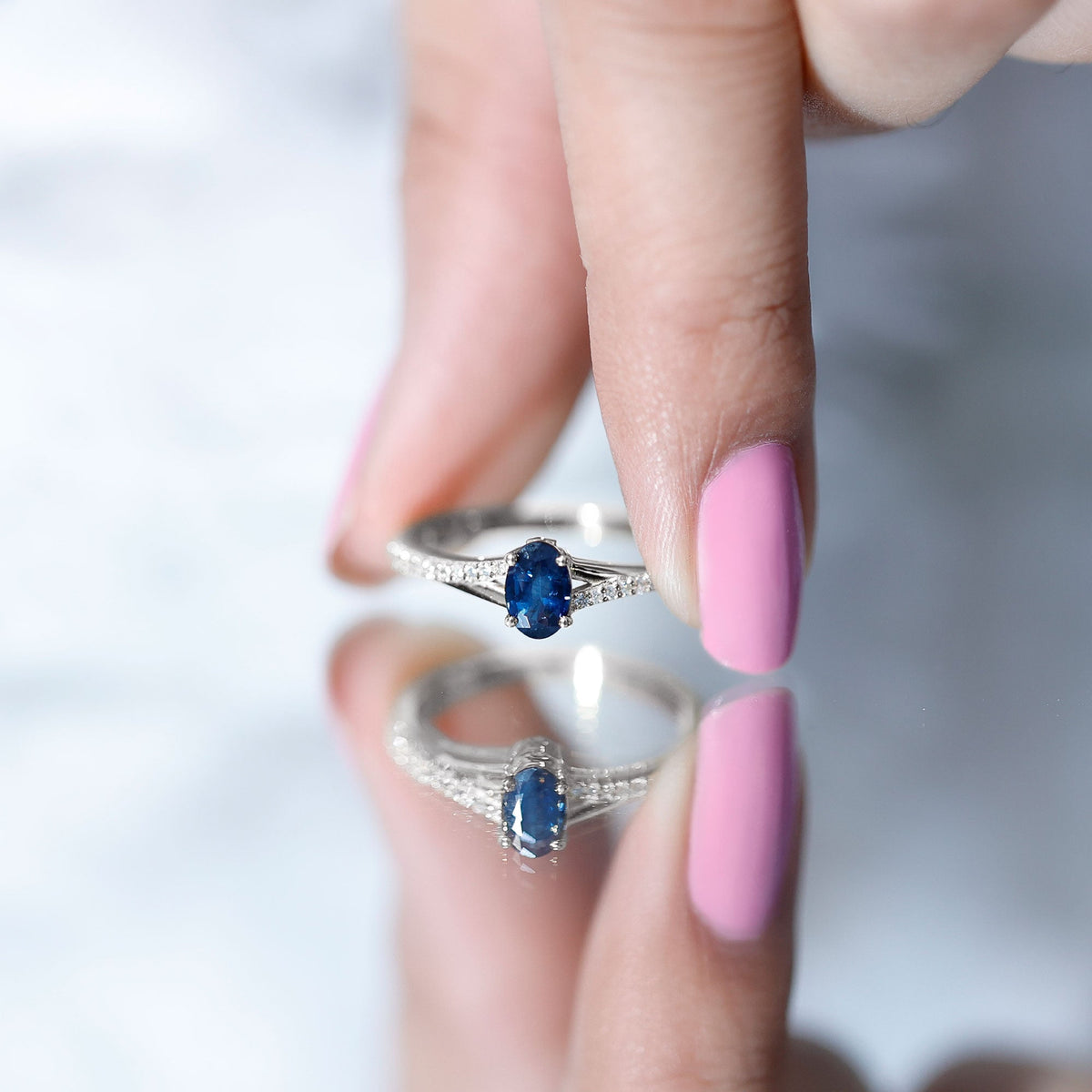 Natural 0.6 carat blue sapphire engagement ring with diamond split shank by Rosec Jewels, showcasing a elegant, minimalist design.