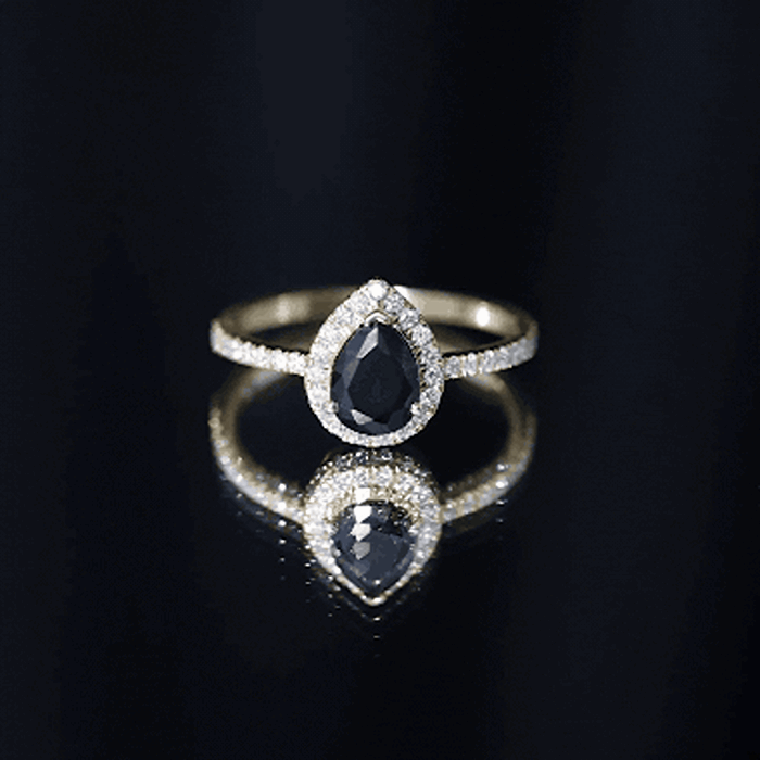 Lab grown black diamond teardrop engagement ring with white diamond halo by Rosec Jewels, showcasing sparkling gemstones and elegant design.