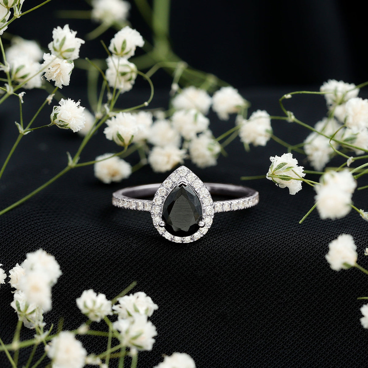 Lab grown black diamond teardrop engagement ring with white diamond halo, crafted by Rosec Jewels.