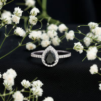 Lab grown black diamond teardrop engagement ring with white diamond halo, crafted by Rosec Jewels.