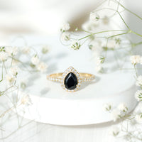 Lab grown black diamond teardrop engagement ring with white diamond halo from Rosec Jewels, featuring a 0.85 carat center stone.