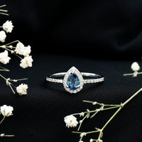 Natural half carat blue sapphire teardrop engagement ring with diamond halo by Rosec Jewels, showcasing a stunning blue sapphire center.