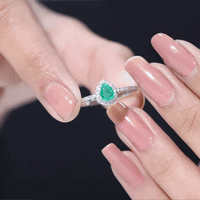 Yellow gold engagement ring featuring a 0.3 carat pear cut emerald teardrop center stone with a diamond halo by Rosec Jewels.