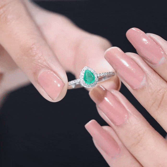 Yellow gold engagement ring featuring a 0.3 carat pear cut emerald teardrop center stone with a diamond halo by Rosec Jewels.