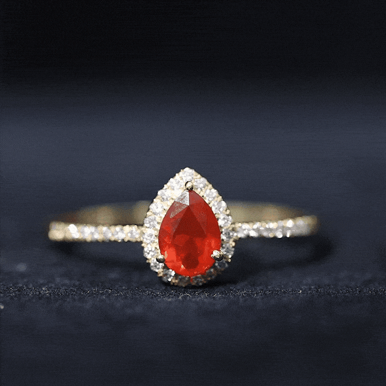 Genuine fire opal teardrop ring with diamond halo from Rosec Jewels, showcasing a vibrant orange gemstone and sparkling diamonds.