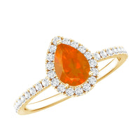 Genuine fire opal teardrop ring with diamond halo, featuring a sparkling gemstone and elegant silver setting.
