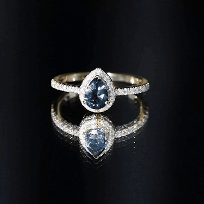 Pear shape London Blue Topaz engagement ring with moissanite halo, set in yellow gold, by Rosec Jewels.