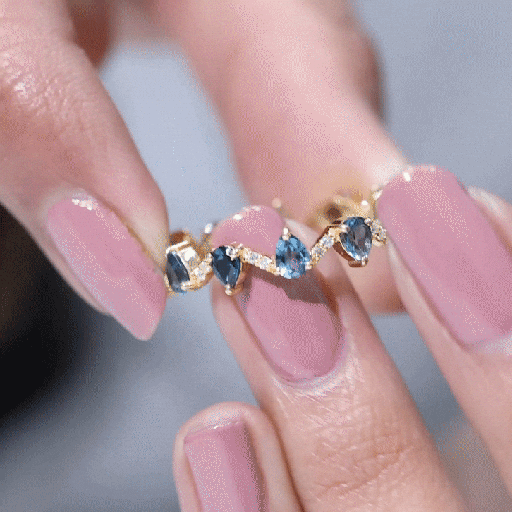 Pear shape London Blue Topaz and diamond eternity ring by Rosec Jewels, showcasing a full band with vibrant blue gemstones and sparkling diamonds.