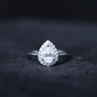 Yellow gold teardrop engagement ring with a 0.7 carat brilliant cut moissanite by Rosec Jewels, featuring a elegant design.