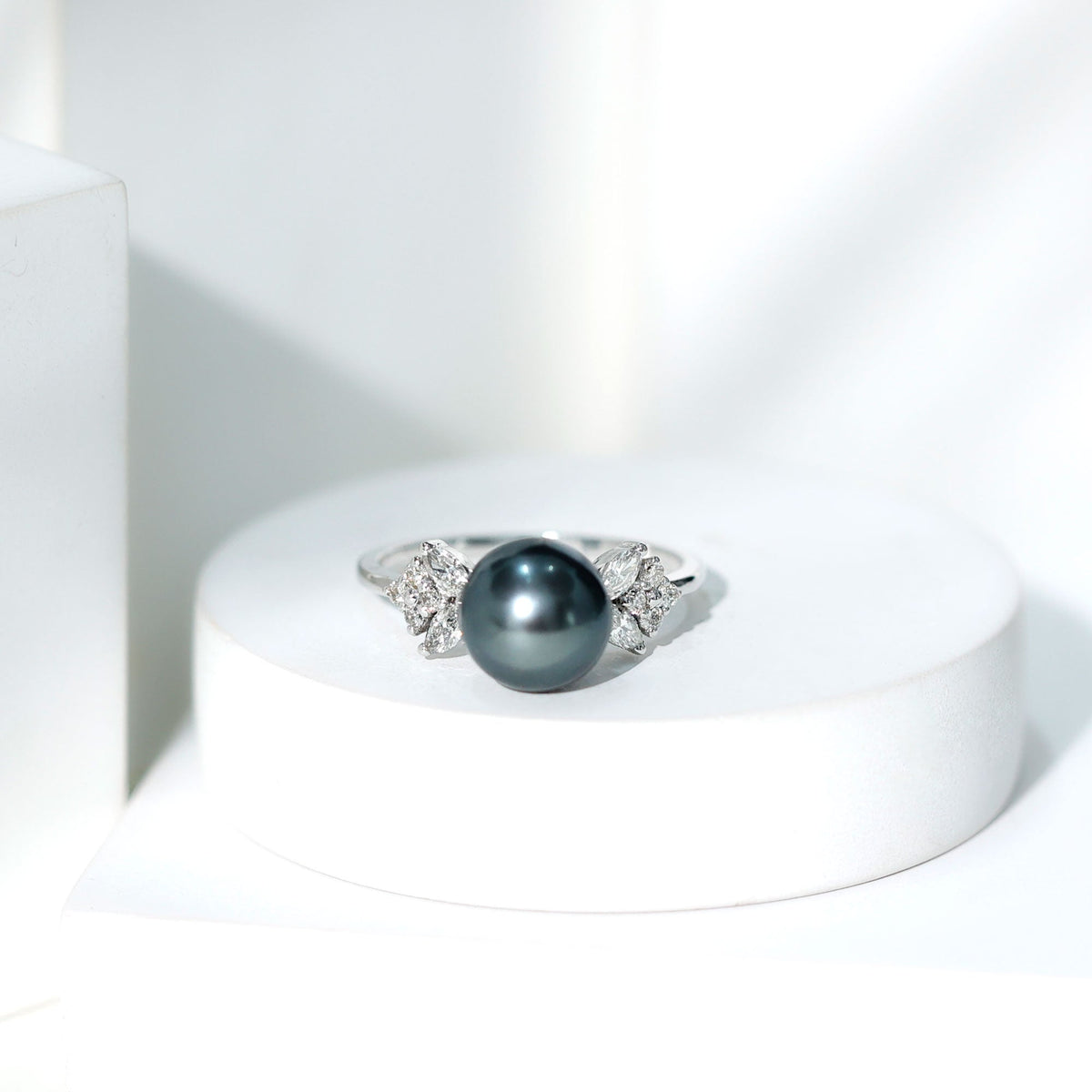 Nature-inspired Tahitian pearl engagement ring with diamond accents, featuring a Rosec Jewels design and intricate metalwork.