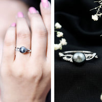 Tahitian pearl and diamond crossover engagement ring by Rosec Jewels featuring a pearl centerpiece and sparkling diamonds.