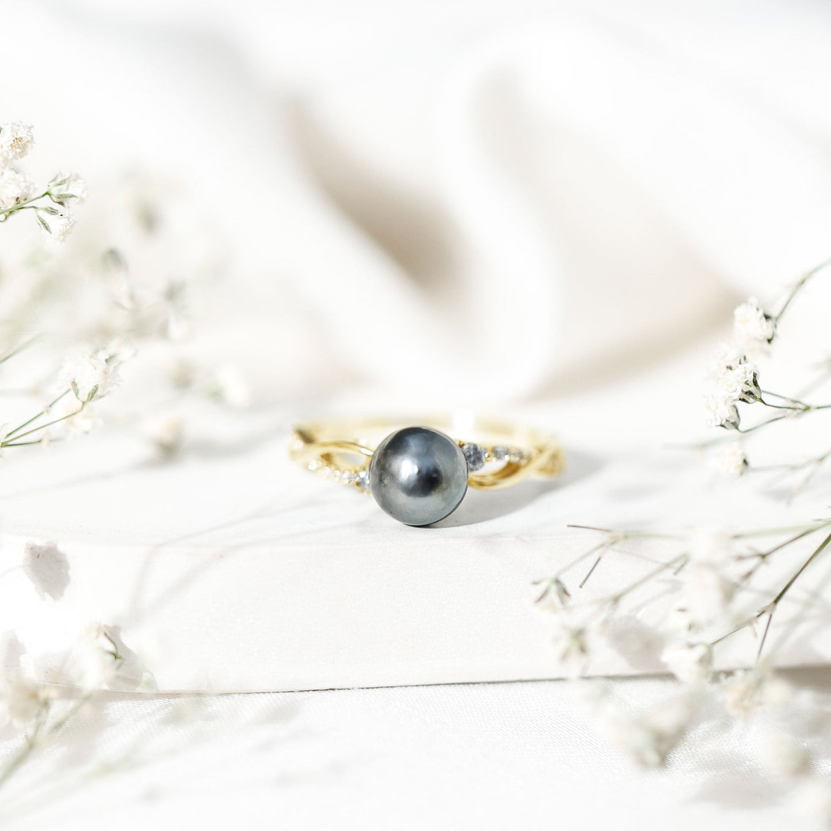 Tahitian pearl and diamond crossover engagement ring by Rosec Jewels featuring elegant design and sparkling gemstones.