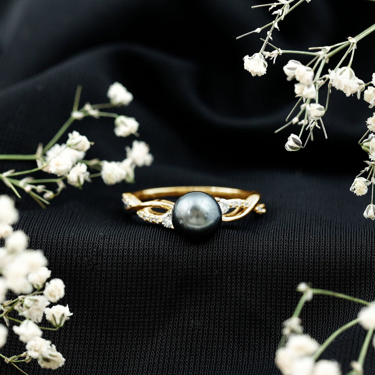 Tahitian pearl and diamond crossover engagement ring by Rosec Jewels featuring a pearl center with diamond accents.