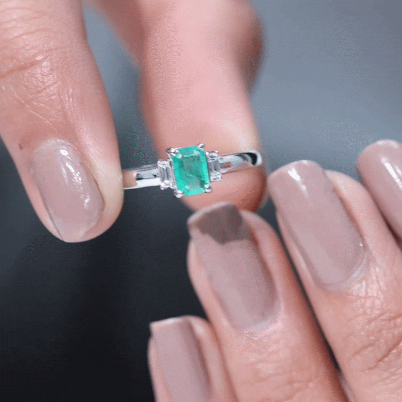Emerald cut emerald and diamond 3-stone promise ring for her by Rosec Jewels, featuring a yellow gold band and sparkling gemstones.