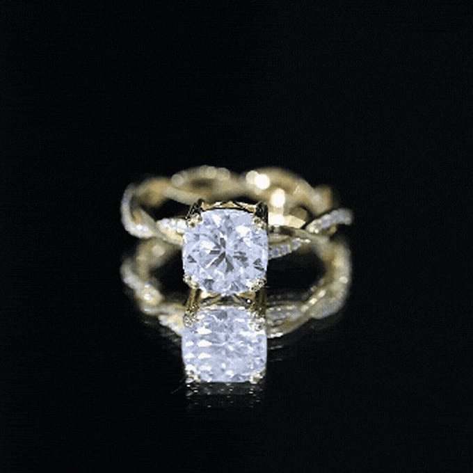Yellow gold cushion cut solitaire moissanite braided engagement ring with intricate design from Rosec Jewels.