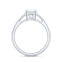 Emerald cut moissanite side stone engagement ring by Rosec Jewels with a central emerald cut moissanite and side stones on a silver band.