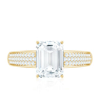Emerald cut moissanite side stone engagement ring from Rosec Jewels featuring a central gemstone and side stones in a elegant band.