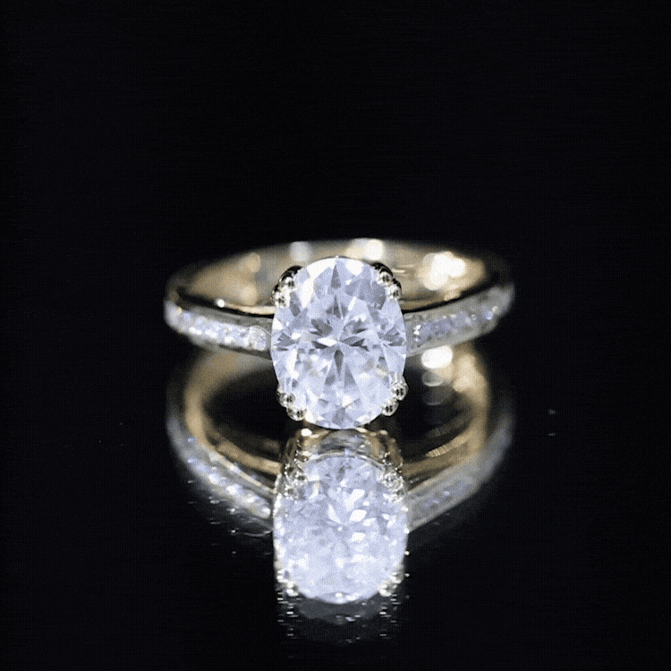 Yellow gold certified moissanite oblong engagement ring in double prong setting with intricate band details.