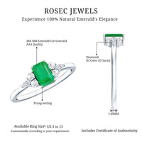 Emerald cut emerald engagement ring with diamond trio accents, showcasing a sparkling gemstone and elegant band design.