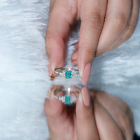 Emerald cut emerald engagement ring with diamond trio accents from Rosec Jewels, showcasing the detailed ring design and gemstones.