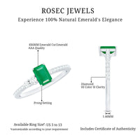 Natural emerald cut emerald engagement ring with diamond side stones, featuring a sleek gold band and intricate detailing.