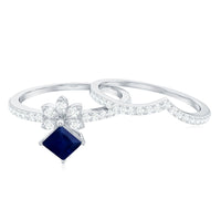 Elegant princess cut blue sapphire and diamond flower wedding ring set by Rosec Jewels, showcasing intricate design and sparkling gemstones.