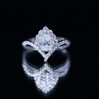 Women's pear-shaped moissanite engagement ring in silver featuring a sparkling solitaire stone, designed by Rosec Jewels.
