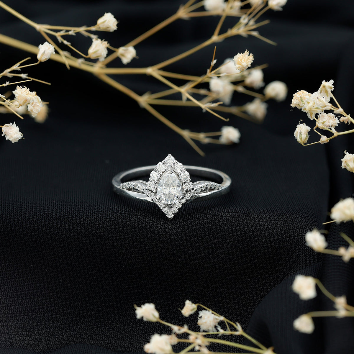 Pear-shaped 0.79 carat moissanite engagement ring by Rosec Jewels, featuring a sleek gold band and sparkling center stone.