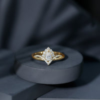 Women's pear-shaped moissanite engagement ring in silver with intricate designer detailing, showcasing the elegant ring design.